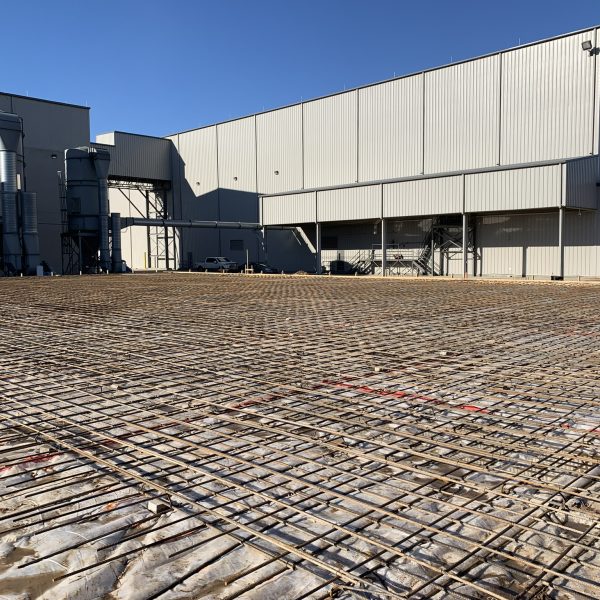 Photo of an industrial installation prepared with rebar for a concrete foundation.